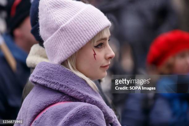 Protester is seen with a lightning bolt symbol for women's strike on her face seen during a protest in Gdansk. Protesters gathered on the Old Town of...
