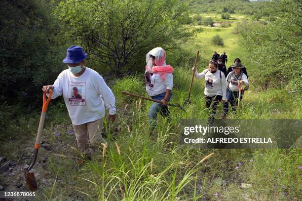 Members of the Madres Buscadoras de Sonora civil organization walk in search of the remains of missing persons, in the outskirts of Hermosillo,...