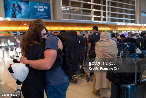 Paloma Camacho hugs at Anthony Long before her flight at Tom Bradley International Terminal on Sunday, Nov. 28, 2021 in Los Angeles, CA. Sunday after...