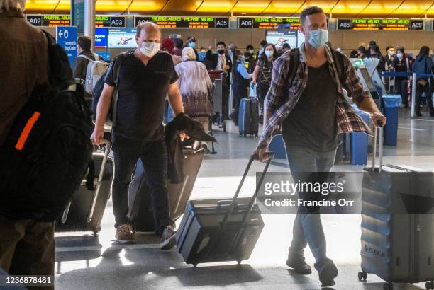 Travelers move quickly through at Tom Bradley International Terminal on Sunday, Nov. 28, 2021 in Los Angeles, CA. Sunday after Thanksgiving is one of...