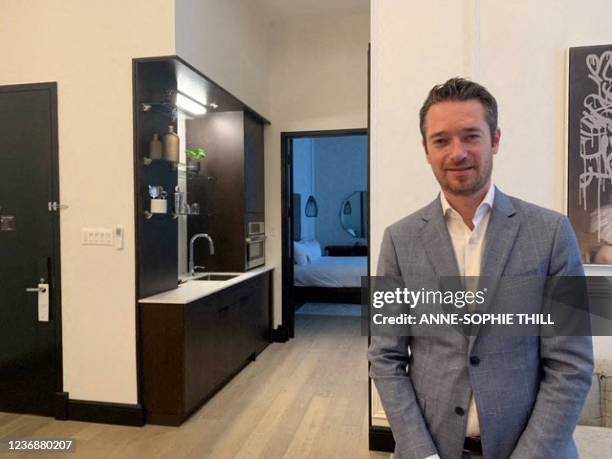 Benoit Pretet who works as a manager in Hotel Place dArmes, in old Montreal, Quebec, poses for a picture on November 11, 2021 - The signs of an...