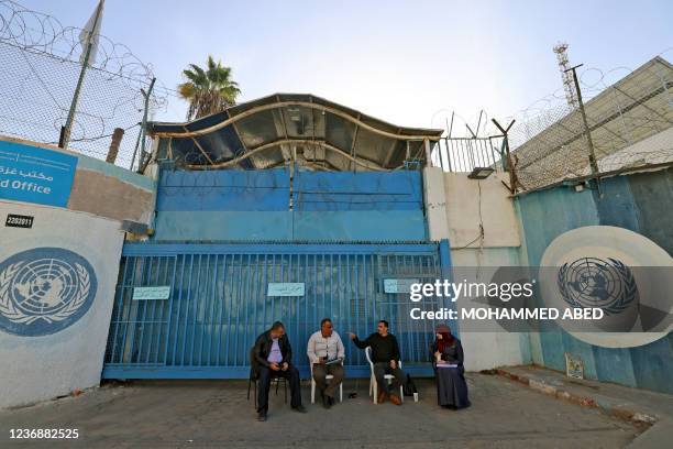 Palestinian teachers sit in front of the headquarters of the United Nations Relief and Works Agency for Refugees in Gaza City during a general strike...