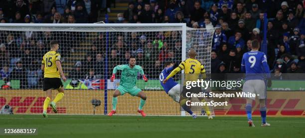 Leicester City's James Maddison beats Watford's William Troost-Ekong to the ball and scores the opening goal during the Premier League match between...