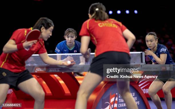 Japan's Ito Mima 1st R/Hayata Hina 2nd L and China's Chen Meng 1st L/Qian Tianyi compete during the women's doubles semifinal match at 2021 World...