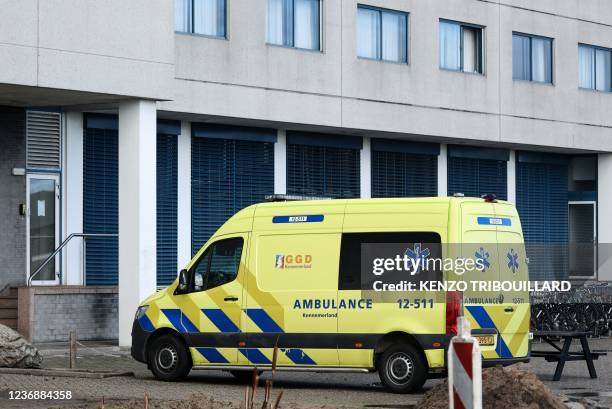 This photograph taken on November 29, 2021 in Badhoevedorp near Schiphol airport, shows an an ambulance parked in front of Ramada Hotel where Dutch...