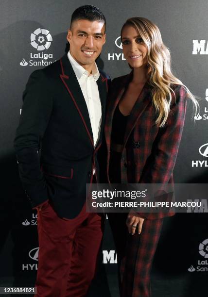 Atletico Madrid's Uruguayan forward Luis Suarez poses with his wife Sofia Balbi as they attend the Football Marca Awards ceremony in Madrid on...