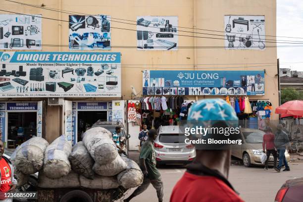 Worker hauls sacks of charcoal fuel along a street in Kinshasa, Democratic Republic of Congo, on Thursday, Nov. 25, 2021. A leak of 3.5 million...