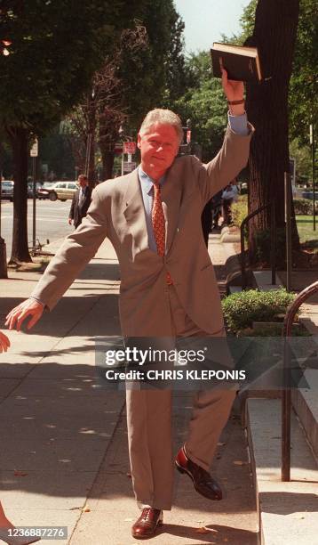 President Bill Clinton waves to onlookers as he arrives at Foundry Methodist Church in Washington, DC, July 05. AFP PHOTO/Chris Kleponis