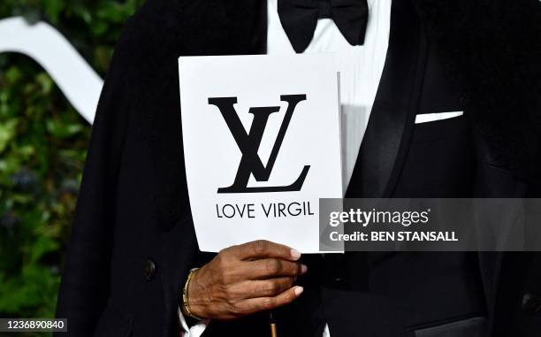 Director Sixx King holds a card reading "Love Virgil", as a mark of respect to designer Virgil Abloh, on the red carpet upon arrival at The Fashion...