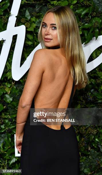 English designer Kimberley Garner poses on the red carpet upon arrival at The Fashion Awards 2021 in London on November 29, 2021. - The Fashion...