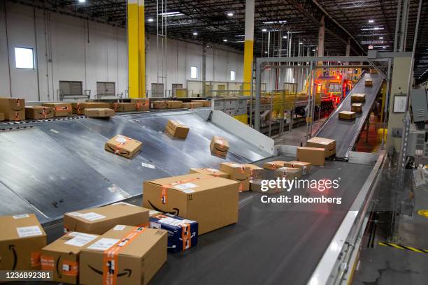 Packages move along a conveyor at an Amazon fulfillment center on Cyber Monday in Robbinsville, New Jersey, U.S., on Monday, Nov. 29, 2021. Adobe...