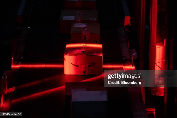 Packages move along a conveyor at an Amazon fulfillment center on Cyber Monday in Robbinsville, New Jersey, U.S., on Monday, Nov. 29, 2021. Adobe...