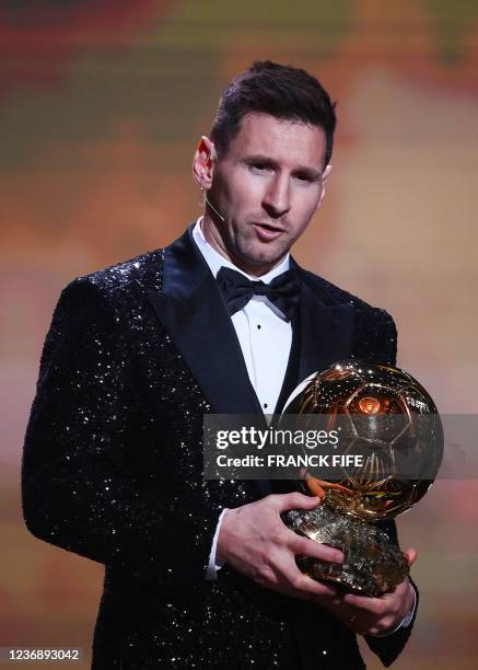 Paris Saint-Germain's Argentine forward Lionel Messi poses after being awarded the the Ballon d'Or award during the 2021 Ballon d'Or France Football...