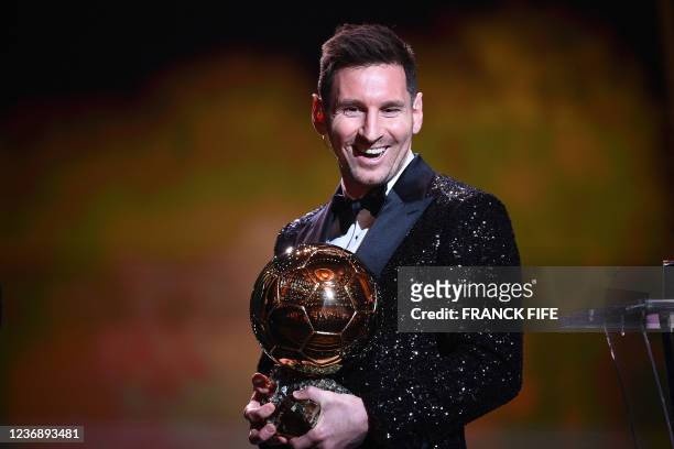 Paris Saint-Germain's Argentine forward Lionel Messi reacts after being awarded the the Ballon d'Or award during the 2021 Ballon d'Or France Football...