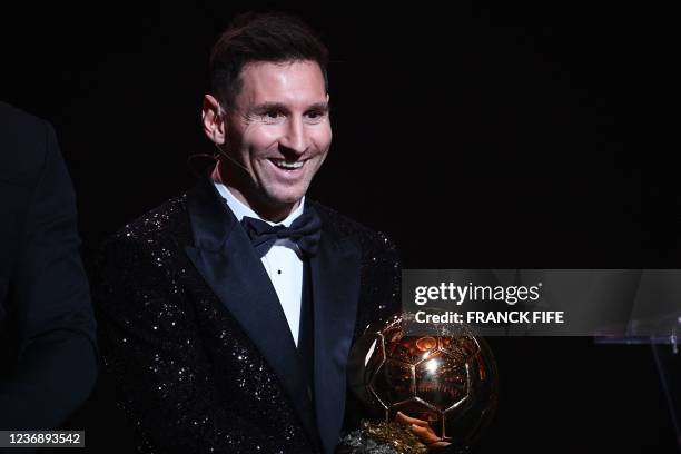 Paris Saint-Germain's Argentine forward Lionel Messi poses after being awarded the the Ballon d'Or award during the 2021 Ballon d'Or France Football...