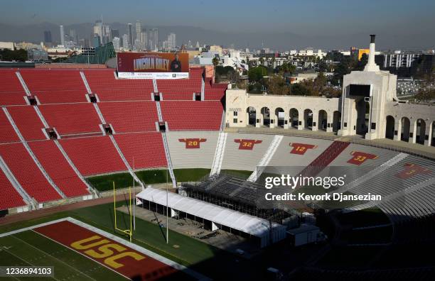 Large screen at the Los Angeles Coliseum display a photo of the new USC football head coach Lincoln Riley, with downtown Los Angeles as the...