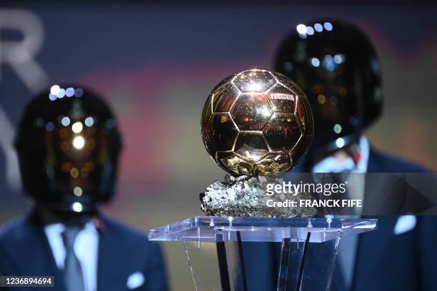 Formula One drivers Fernando Alonso of Spain and Esteban Ocon of France present the trophy for the the Ballon d'Or award during the 2021 Ballon d'Or...