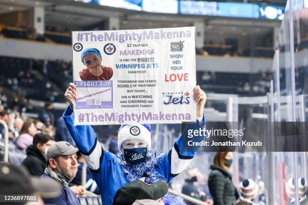 Fan holds up a sign during the pre-game warm up prior to NHL action between the Winnipeg Jets and the Arizona Coyotes at the Canada Life Centre on...