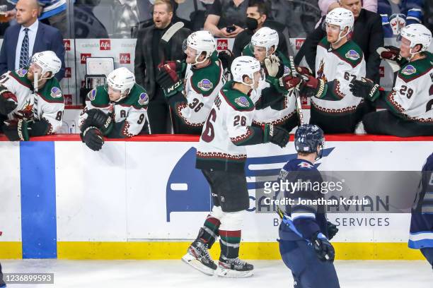 Antoine Roussel of the Arizona Coyotes celebrates his second period goal against the Winnipeg Jets with teammates at the bench at the Canada Life...