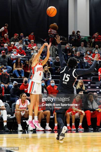 Ohio State Buckeyes guard Jacy Sheldon shoots a three pointer over Cincinnati Bearcats forward Arame Niang in a game between the Cincinnati Bearcats...