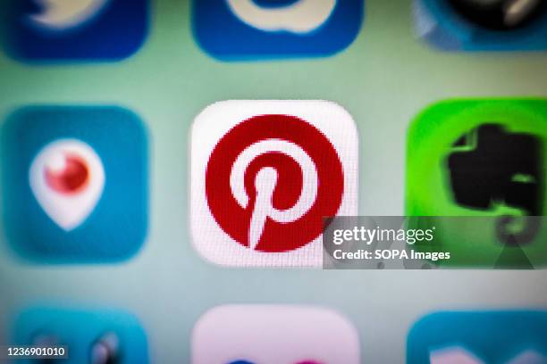 In this photo illustration, a Pinterest app icon is displayed among other apps on a smartphone screen.