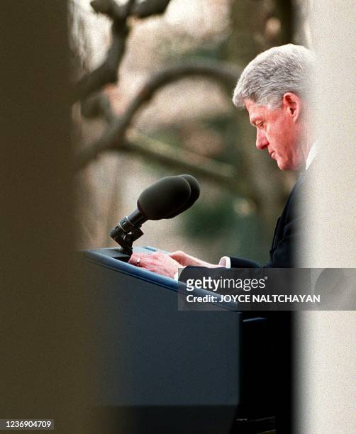 President Bill Clinton reads a statement to the media 12 February in the Rose Garden at the White House in Washington after he was acquitted 12...