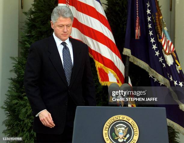 President Bill Clinton walks to the podium moments before reading a statement in the Rose Garden of the White House after the Senate voted not to...