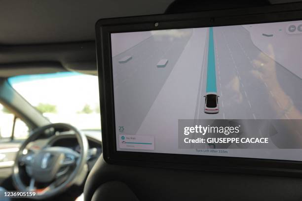 This picture taken on November 30, 2021 shows a view of passengers monitor showing road navigation, from the interior of one of the self-driving...