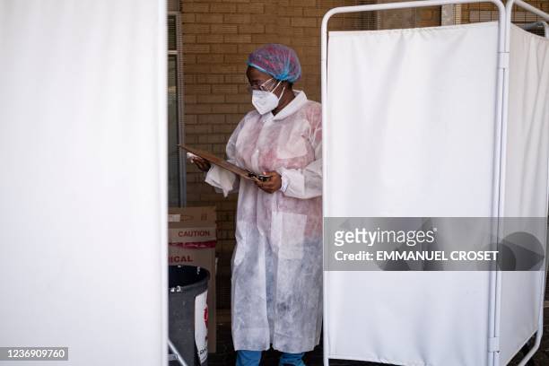 Healthcare worker prepares to conduct a PCR Covid-19 test at the Lancet laboratory in Johannesburg on November 30, 2021. - A new, heavily mutated...