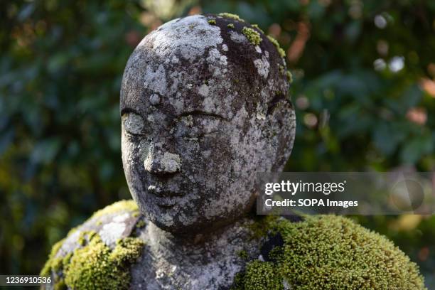 Buddha stone statue covered with moss is seen inside the Eikando Zenrin-ji Temple in Kyoto. Eikando Zenrin-ji Temple is one of the oldest temples in...