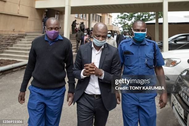 Suspended President of Football Kenya Federation Nick Mwendwa is led in handcuffs by police offciers to the anti-corruption court to appear over...