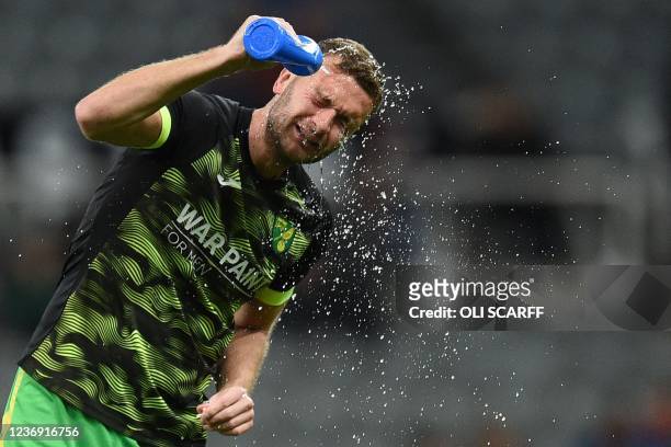 Norwich City's English defender Ben Gibson sprays water over his face ahead of the English Premier League football match between Newcastle United and...