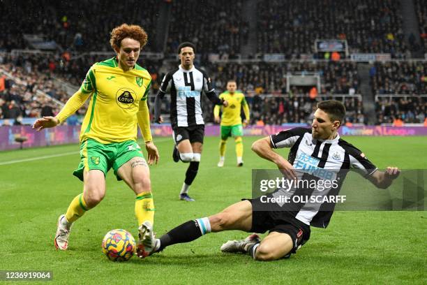 Newcastle United's Argentinian defender Federico Fernandez tackles Norwich City's US striker Josh Sargent during the English Premier League football...