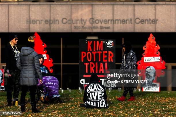 People gather outside the Hennepin County Government Center in Minneapolis on November 30, 2021. - Jury selection begins today in the trial of Kim...