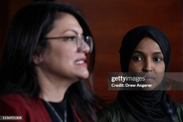 Rep. Ilhan Omar listens as Rep. Rashida Tlaib speaks during a news conference about Islamophobia on Capitol Hill on November 30, 2021 in Washington,...