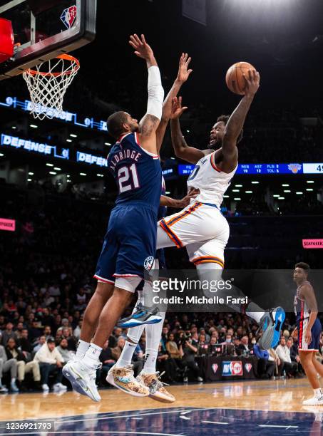 Julius Randle of the New York Knicks makes a shot against LaMarcus Aldridge of the Brooklyn Nets at Barclays Center on November 30, 2021 in the...