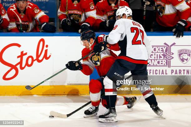 Sam Reinhart of the Florida Panthers gets tangled with Lars Eller of the Washington Capitals at the FLA Live Arena on November 30, 2021 in Sunrise,...