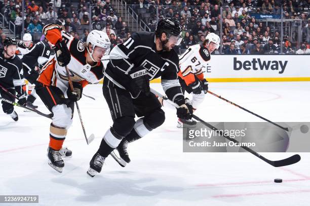Drew Doughty of the Los Angeles Kings skates with the puck with pressure from Trevor Zegras of the Anaheim Ducks during the second period at STAPLES...