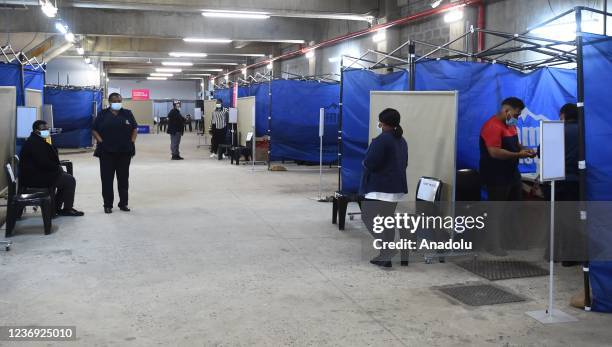 View of a vaccination station as people arrive to receive a dose of Covid-19 vaccines following the detection of the new omicron variant of the...