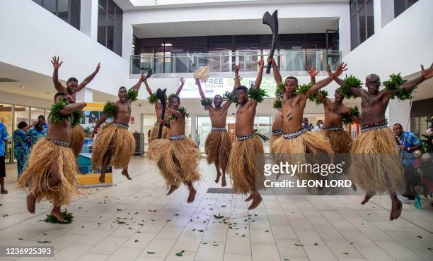 Traditional dancers in grass skirts welcome holidaymakers in Nadi on December 1 as Fiji opens its borders to international travellers for the first...