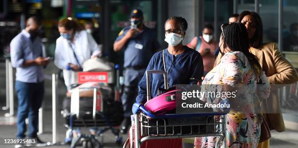 People are seen at Cape Town International Airport as number of passengers reduced following the detection of the new omicron variant of the...