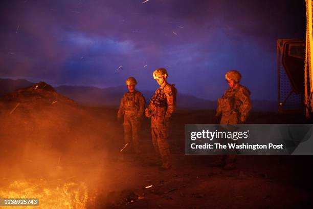 Sgt. Joshua Hollars of El Paso, Texas and two other soldiers from burn trash from the Jaghatu Combat Outpost in a pit, located just outside the walls...