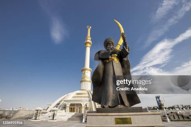 View of statue of Turkmen Seljuk Bey as the Independence Monument stands behind in Ashgabat, Turkmenistan on November 24, 2021.