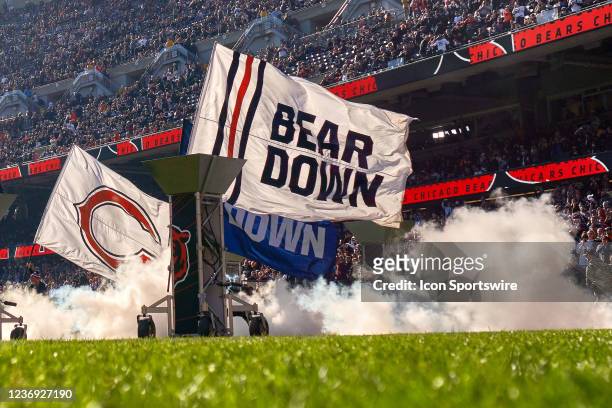 Chicago Bears cheerleaders run with flags onto the field prior to a game between the Chicago Bears and the Baltimore Ravens on November 21, 2021 at...