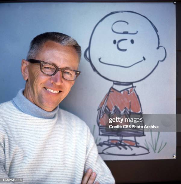 Charles M. Schulz with a drawing of Charlie Brown, one of his Peanuts characters. Image dated January 1, 1962.