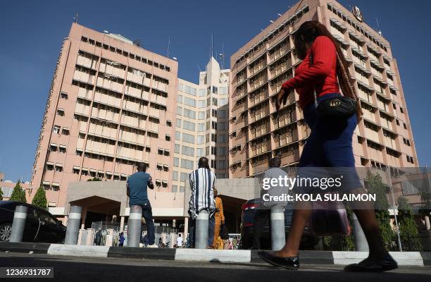 Unvaccinated workers sit after being barred into offices for not complying with compulsory vaccination at the State Secretariat in Abuja, Nigeria, on...