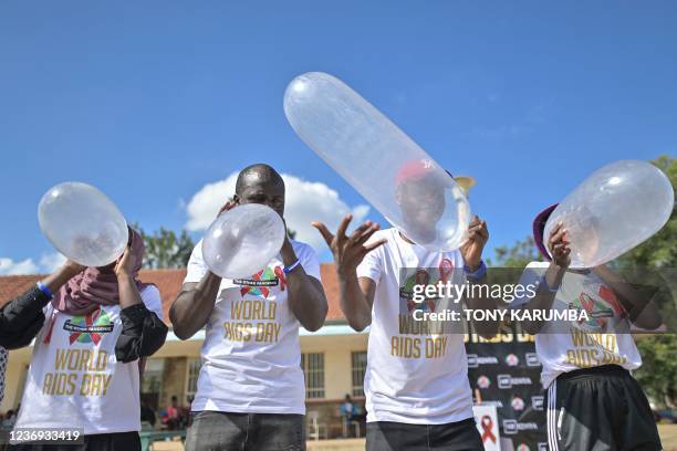 Peer educators compete to inflate condoms during a 'condom olympics' presided over by self declared 'Africa King of Condoms', Stanley Ngara, a kenya...