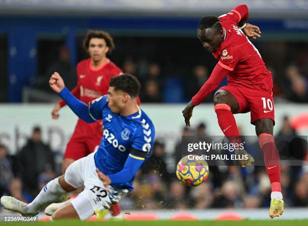 Liverpool's Senegalese striker Sadio Mane shoots but fails to score during the English Premier League football match between Everton and Liverpool at...