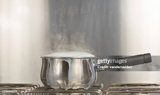 saucepan of boiling milk - boiling stock pictures, royalty-free photos & images
