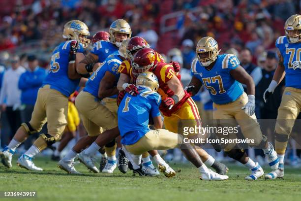 Trojans defensive lineman Nick Figueroa sacks UCLA Bruins quarterback Dorian Thompson-Robinson during a college football game between the UCLA Bruins...